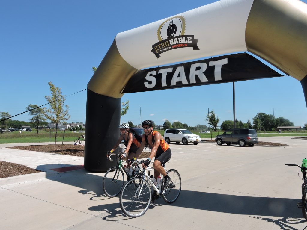 Bikers cross the starting line during Iowa City’s biking event, granGABLE