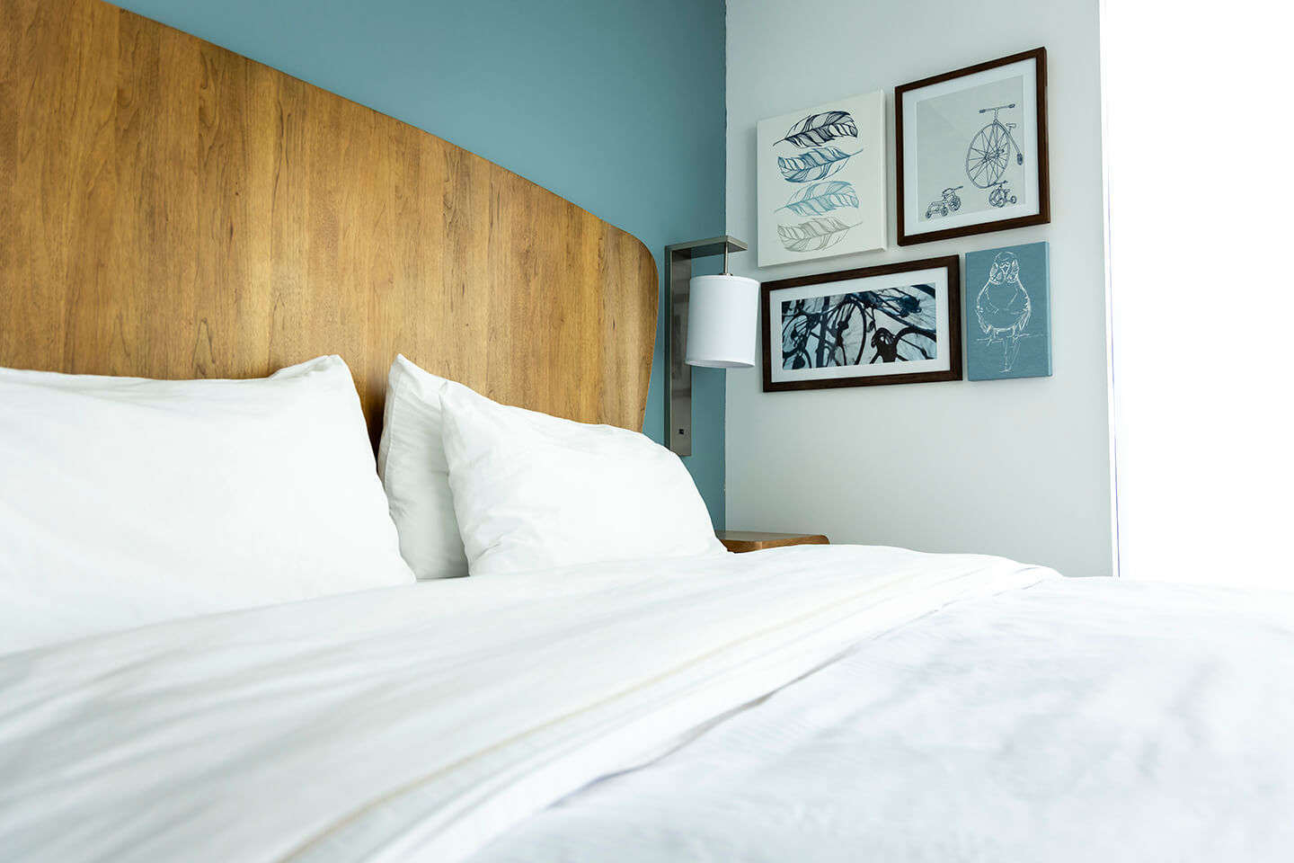 a bed with white sheets and pillows