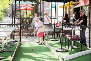 a family playing mini golf