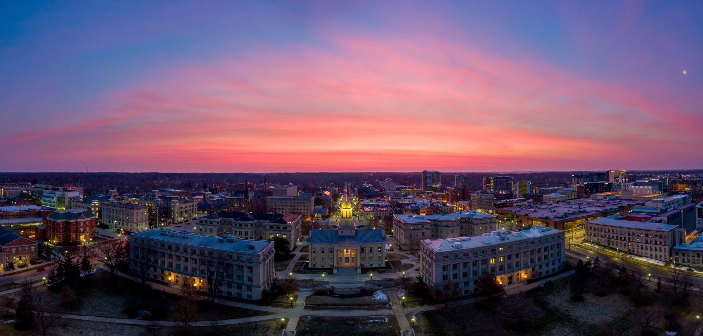 a city with many buildings and a pink sky